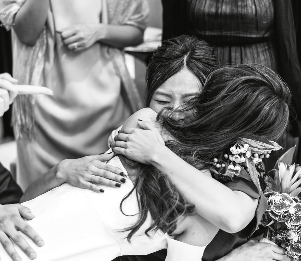 Moved bride hugging her friends