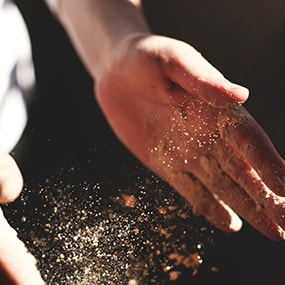 Hands clapping to get rid of flour