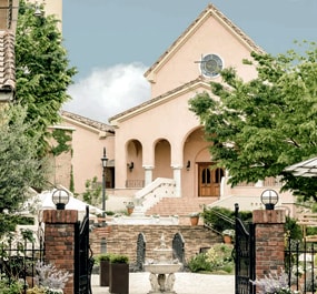 Provence style building with water fountain and chapel